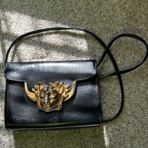 Chic Black Crossbody Bag with Gold Lion Accent